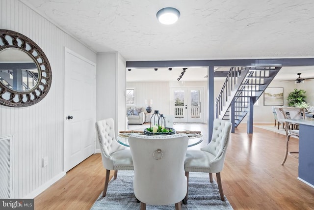 dining room with wood-type flooring and french doors