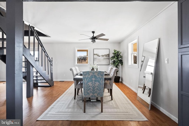 dining space with dark wood-type flooring and ceiling fan