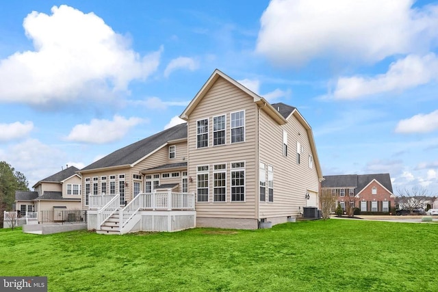 rear view of house with cooling unit, a lawn, and a wooden deck