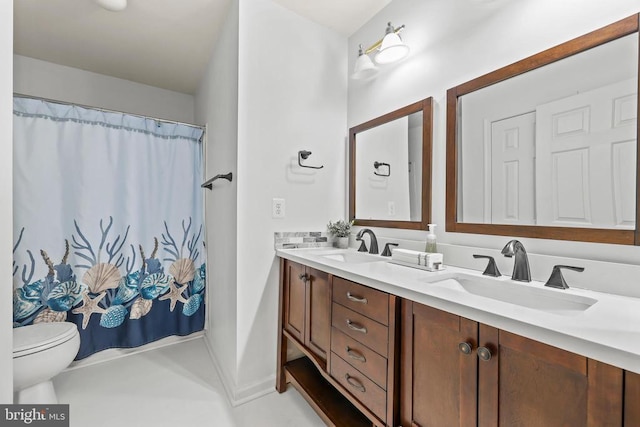 full bathroom with double vanity, a shower with curtain, toilet, and a sink