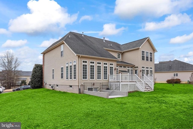 rear view of property featuring a deck and a yard