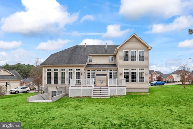 rear view of house featuring a deck and a yard