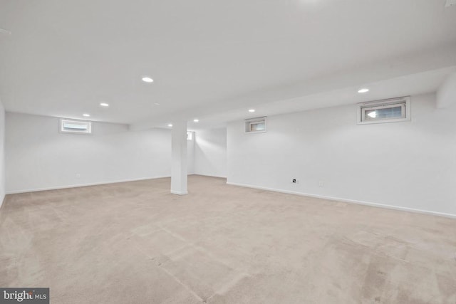 below grade area with recessed lighting, baseboards, and light colored carpet