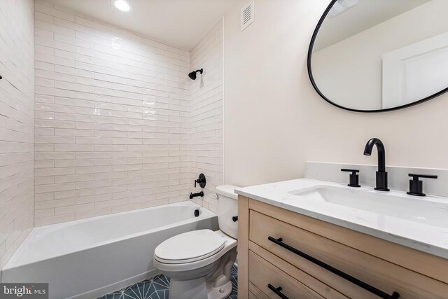 full bathroom featuring vanity, toilet, and tiled shower / bath combo