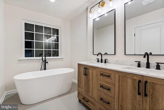 bathroom with vanity, a bath, and tile patterned floors