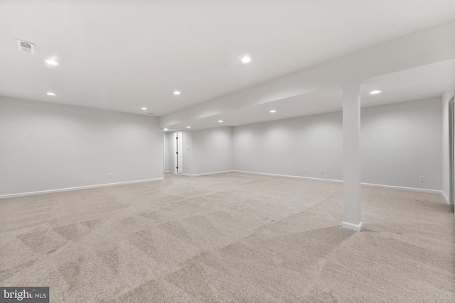 basement featuring light carpet