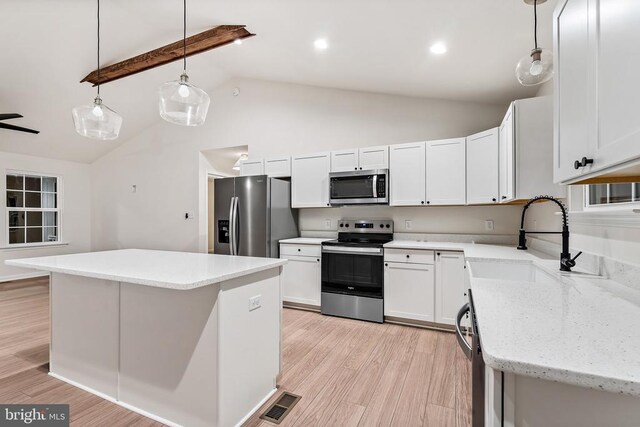 kitchen with sink, white cabinetry, a center island, pendant lighting, and stainless steel appliances