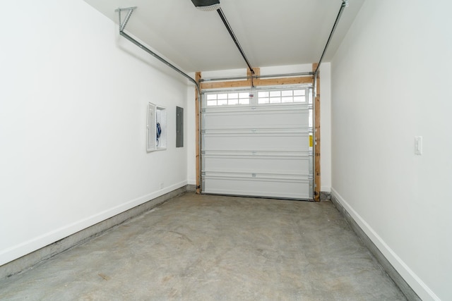 garage with electric panel and baseboards
