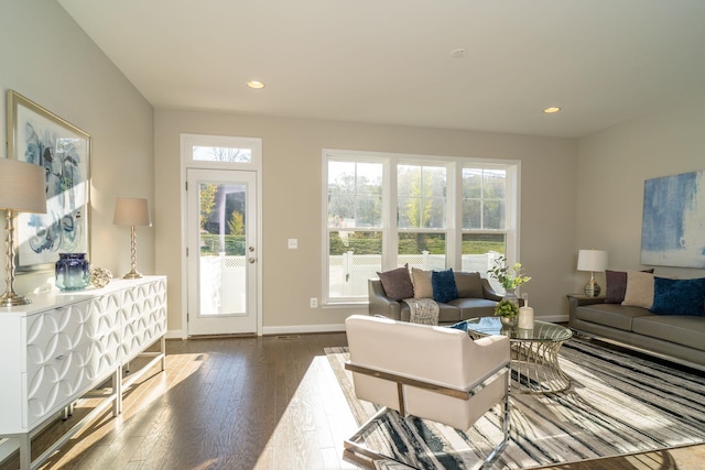 living room with recessed lighting, baseboards, and dark wood-style flooring