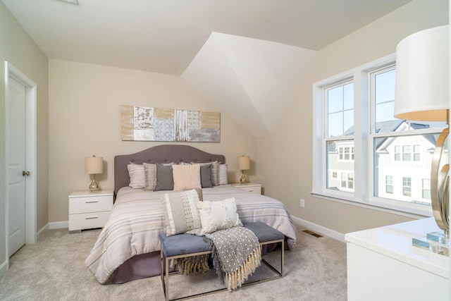 bedroom featuring baseboards, visible vents, and light carpet