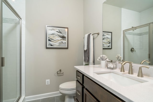 full bathroom featuring tile patterned floors, toilet, a shower stall, baseboards, and vanity