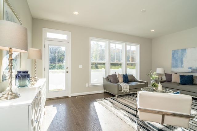 living room with recessed lighting, baseboards, and dark wood-style flooring