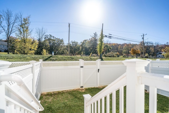 view of yard with fence and a gate