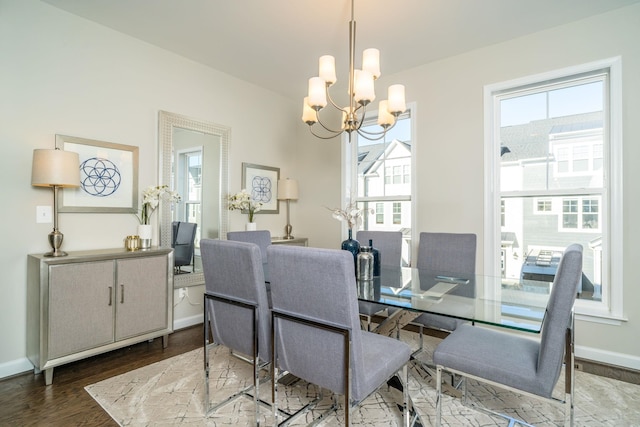 dining room with an inviting chandelier, wood finished floors, and baseboards