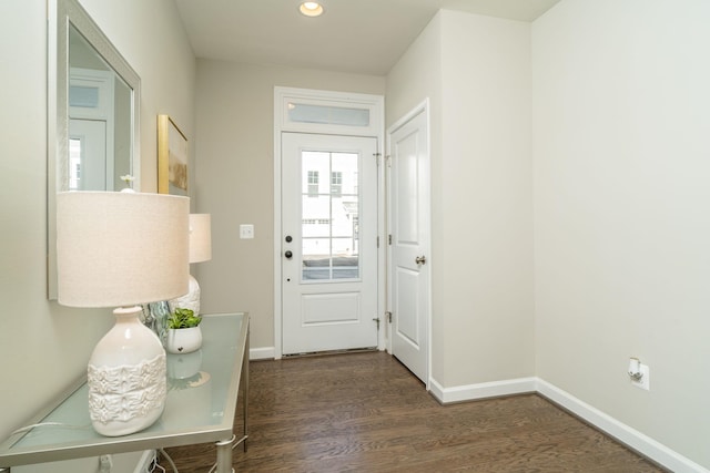 doorway to outside with recessed lighting, wood finished floors, and baseboards