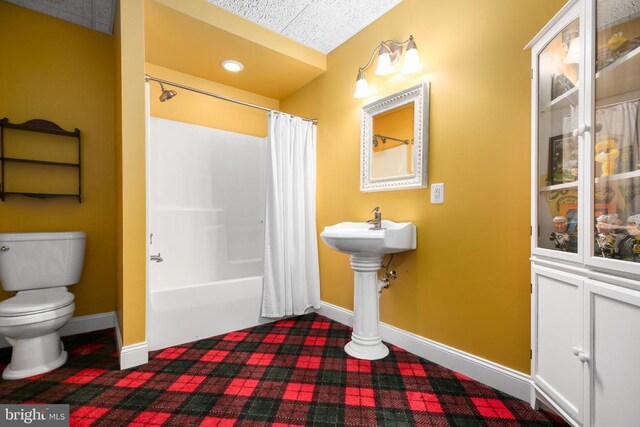 bathroom with shower / tub combo and toilet