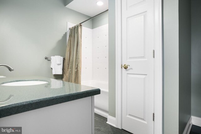 bathroom featuring shower / bathtub combination with curtain and vanity