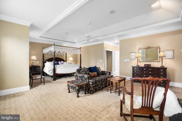 carpeted bedroom with a raised ceiling and crown molding