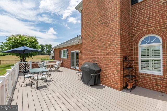 wooden deck with a grill