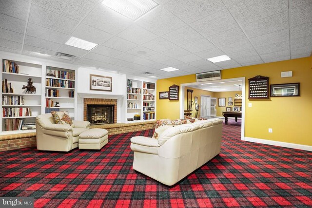 carpeted living room with a brick fireplace and built in features