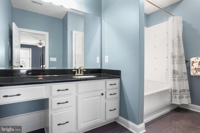 bathroom featuring vanity and shower / tub combo with curtain