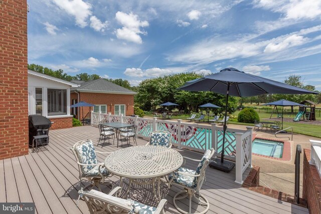 wooden terrace featuring grilling area, a fenced in pool, and a playground