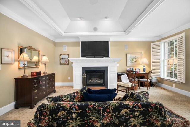 living room featuring crown molding, light carpet, and a tray ceiling