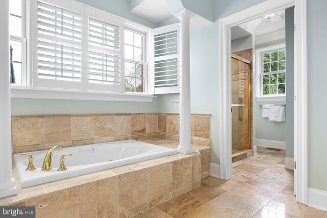 bathroom featuring ornate columns and independent shower and bath