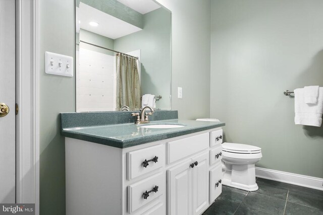 bathroom with walk in shower, vanity, and toilet