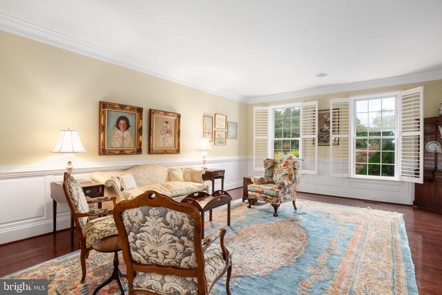 sitting room with ornamental molding and dark hardwood / wood-style floors