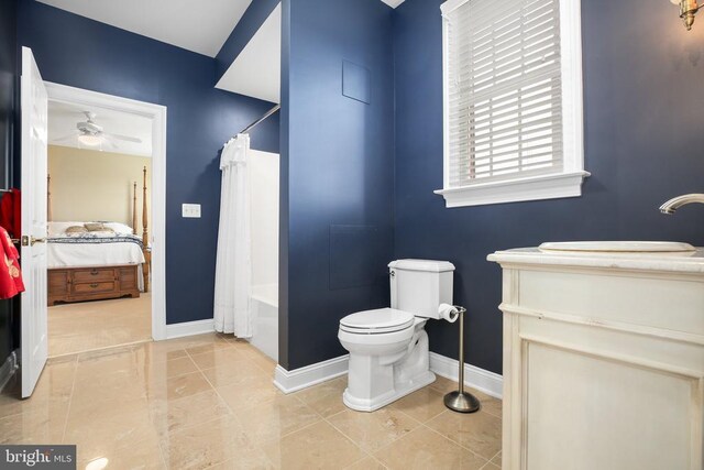 full bathroom with ceiling fan, shower / bath combo, vanity, tile patterned floors, and toilet