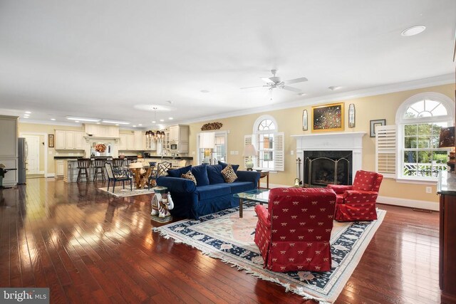 living room featuring crown molding, a wealth of natural light, dark hardwood / wood-style floors, and ceiling fan