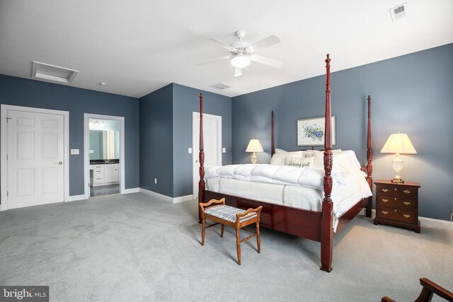 carpeted bedroom with ensuite bath and ceiling fan