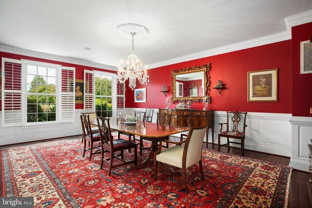 dining area with crown molding, dark hardwood / wood-style floors, and an inviting chandelier