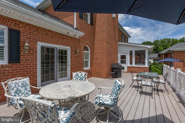 wooden terrace with a grill