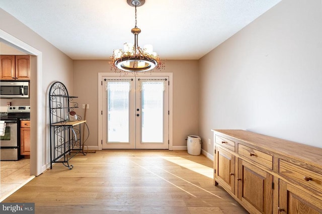 doorway to outside featuring a notable chandelier, french doors, light wood-type flooring, and baseboards