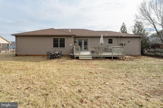 back of property with a deck, fence, a yard, french doors, and crawl space