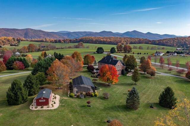 drone / aerial view with a mountain view and a rural view