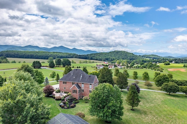 birds eye view of property with a mountain view