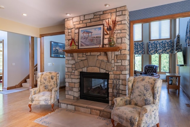 living room featuring wood-type flooring and a fireplace