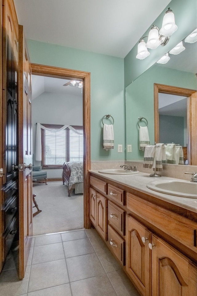 bathroom with vanity, tile patterned flooring, and lofted ceiling