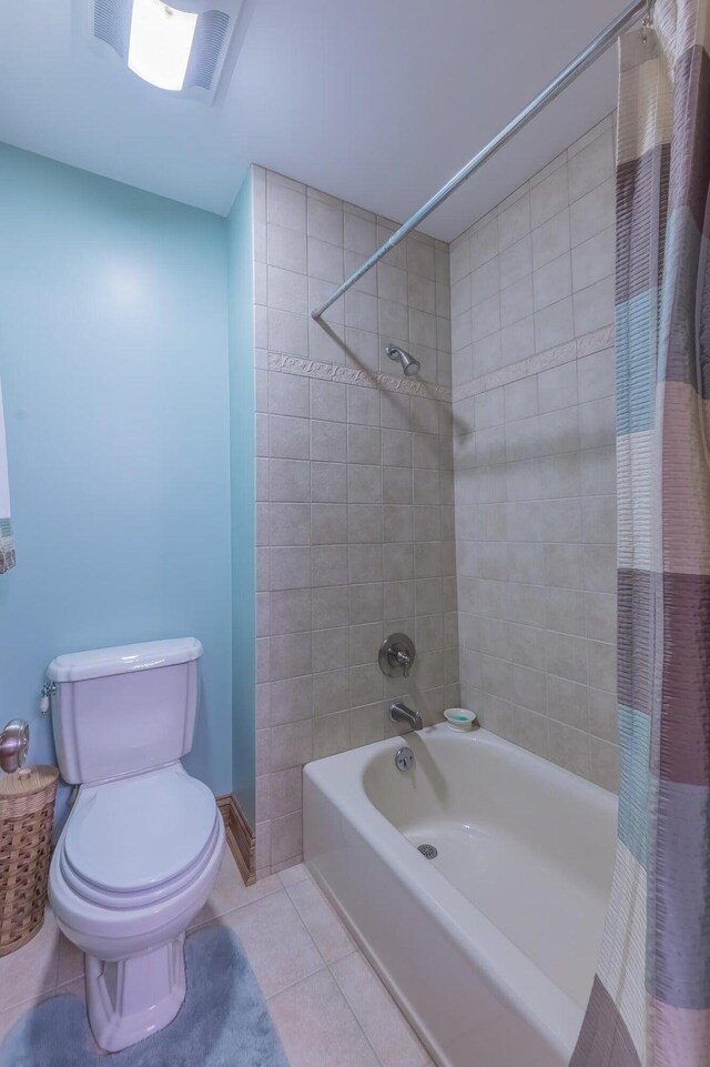 bathroom with shower / bathtub combination with curtain, tile patterned floors, and toilet