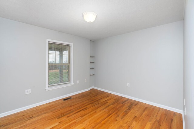 unfurnished room featuring wood-type flooring