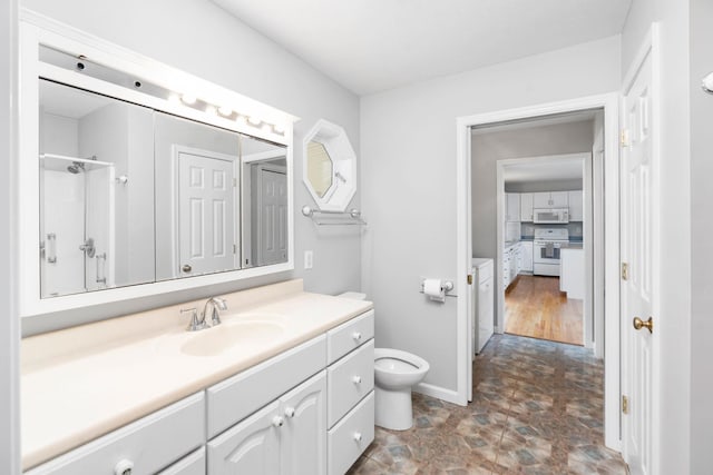 bathroom featuring vanity, a shower, and toilet