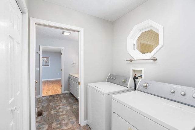 clothes washing area featuring washing machine and clothes dryer