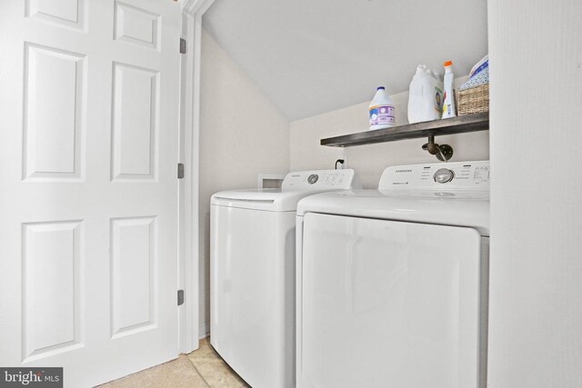 washroom with laundry area, separate washer and dryer, and light tile patterned flooring