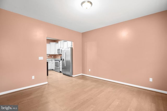 interior space with light wood-style floors and baseboards