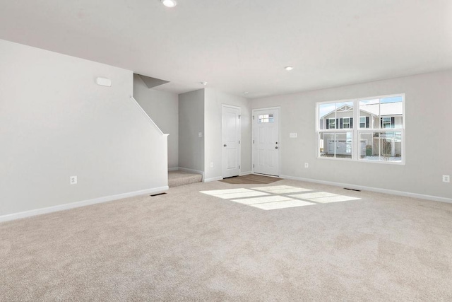 unfurnished living room with light carpet