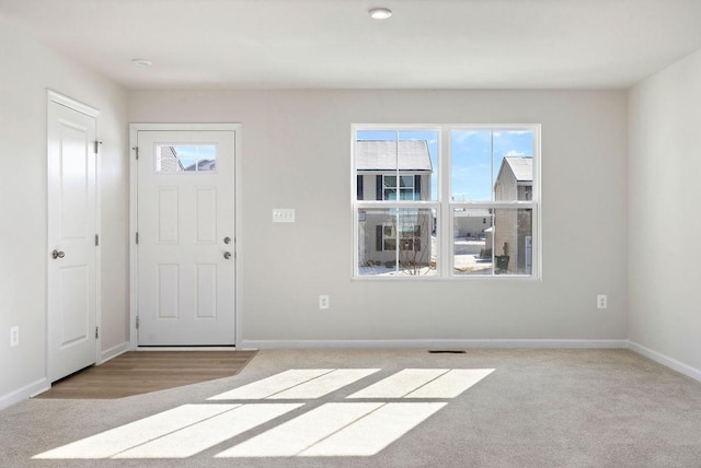 foyer entrance with light colored carpet