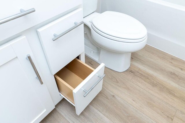 bathroom featuring toilet and hardwood / wood-style floors